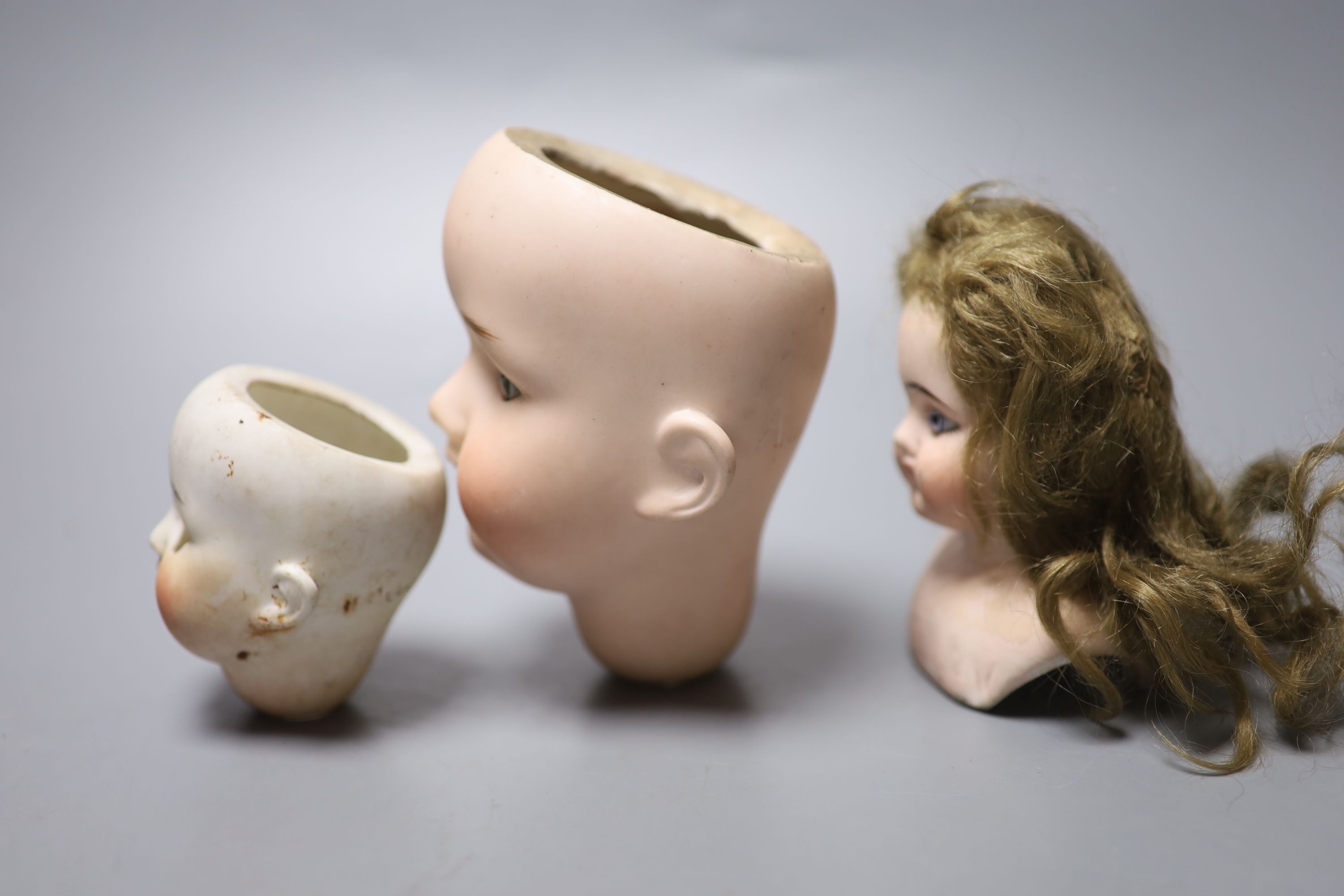 An Armand Marseille 390 bisque doll head, a Heubach Koppelsdorf bisque doll head and other